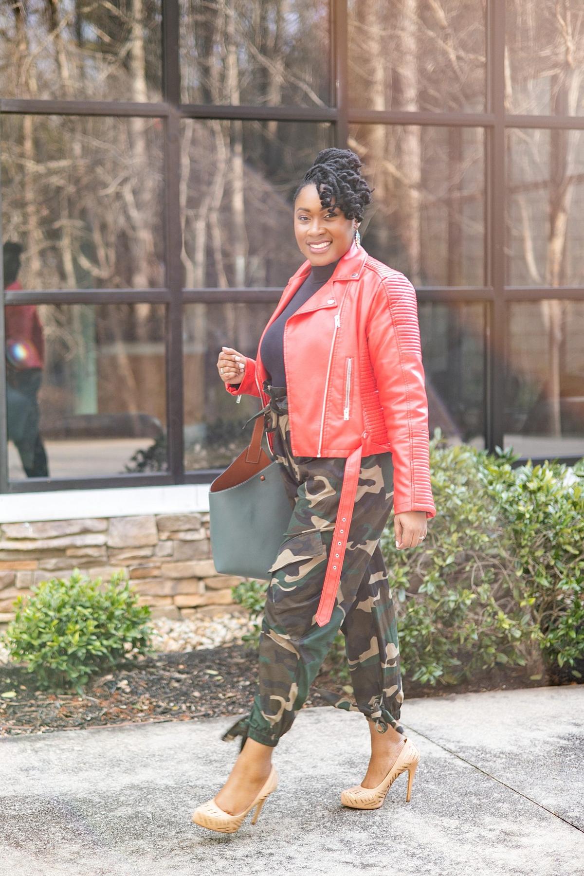Personal branding photo of a businesswoman in a red leather jacket walking outside her office