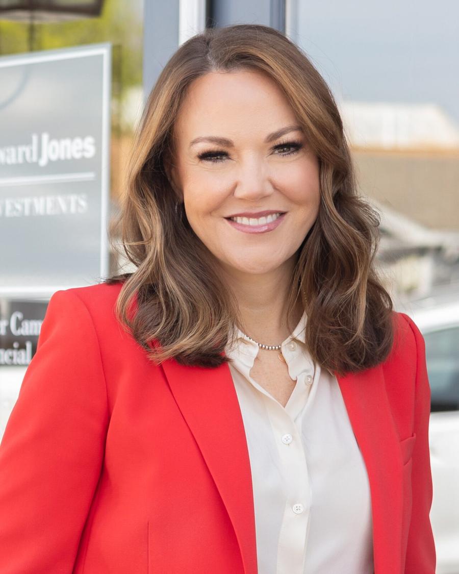 On-location headshot of a financial advisor in a red blazer outside her office