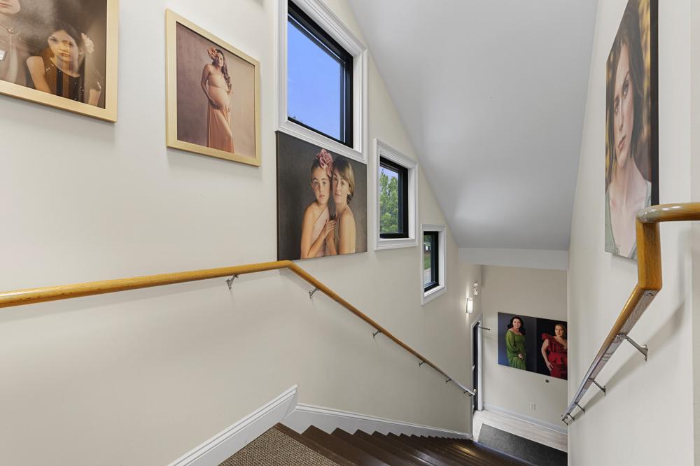 Staircase lined with framed portraits