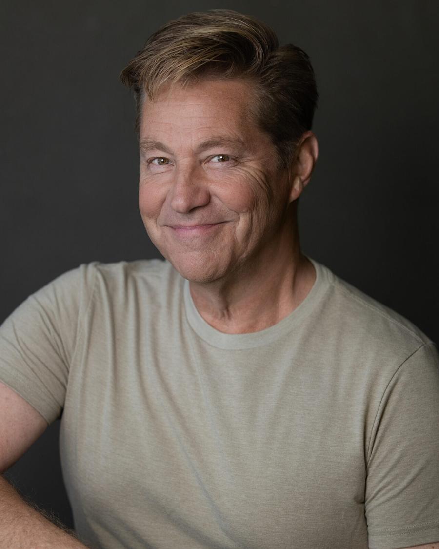 Studio headshot of a smiling man in a sage t-shirt, Tyrone, GA