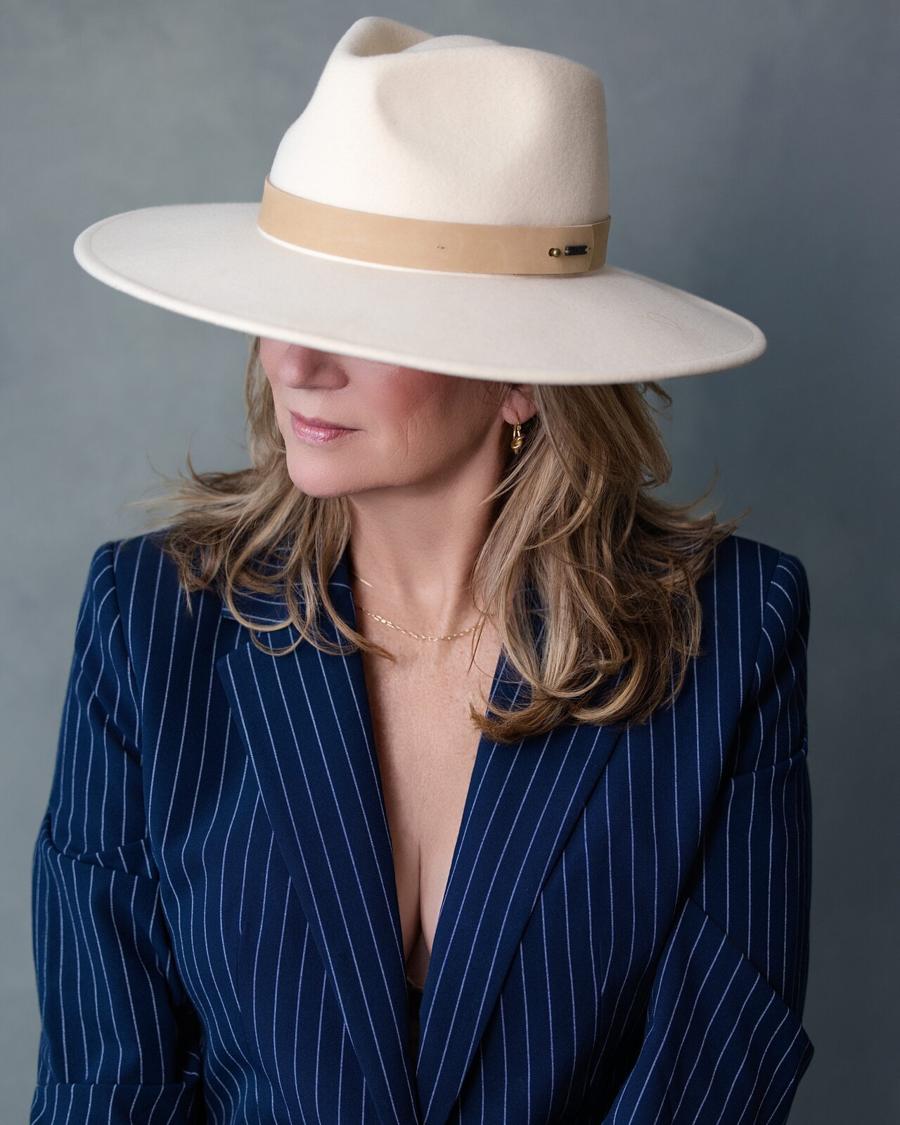 Women's portrait in a cream wide-brim hat and navy pinstripe blazer, Tyrone, GA studio