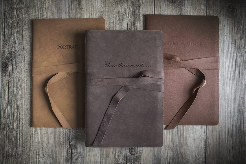Three leather bound storybook albums with hand tied closures
