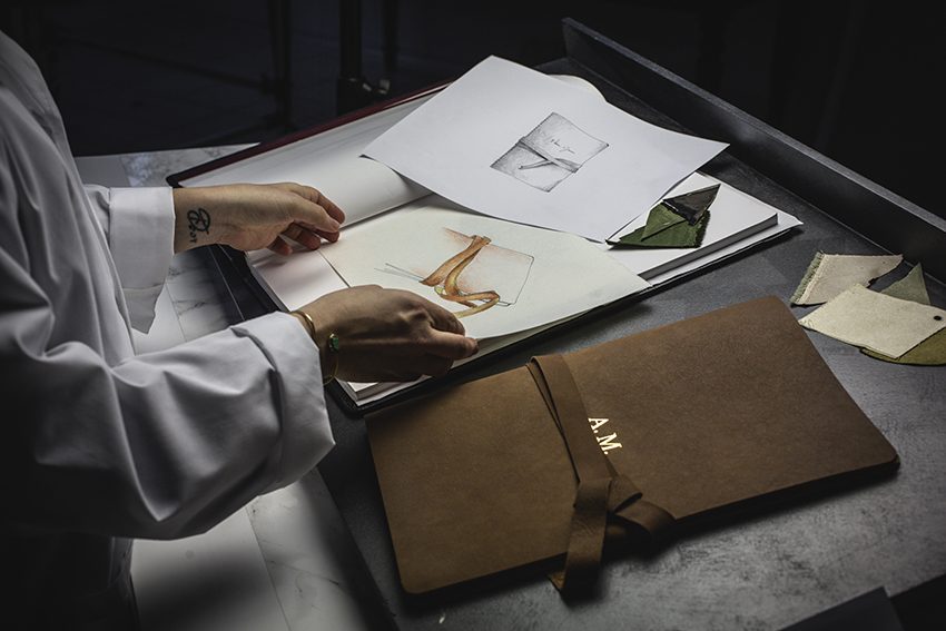 Artisan hand binding a leather album in an Italian workshop